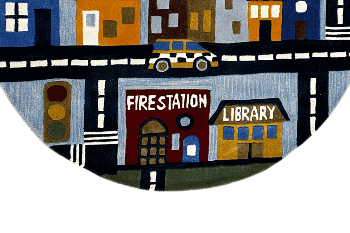 Lower section of the round children's city rug with “Firestation” and “Library”