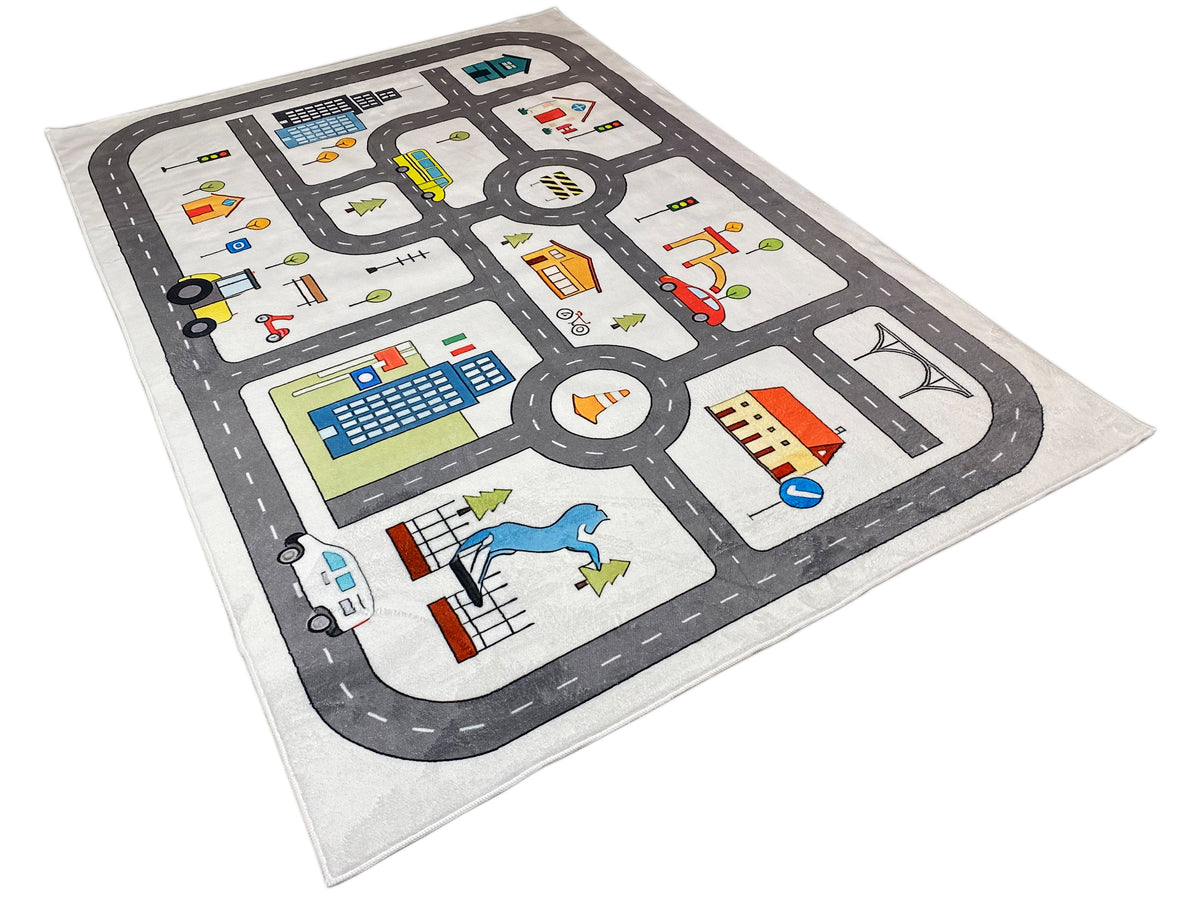 Kinderteppich mit Straßenkreuz, Kreisverkehr und farbigen Gebäuden, grau unterlegt.