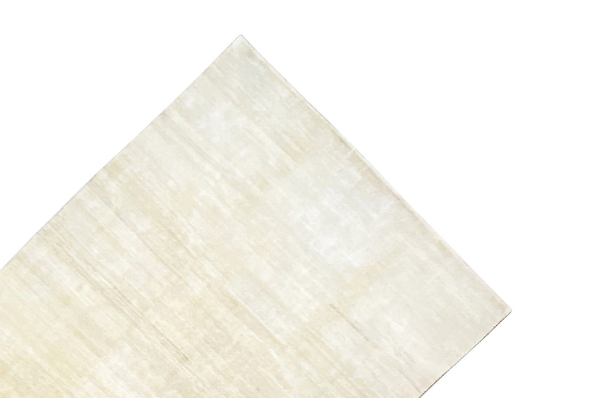 Light beige Gabbeh rug, presented at an angle, with fine lines and an even texture