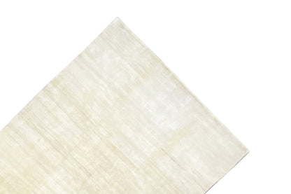 Light beige Gabbeh rug, presented at an angle, with fine lines and an even texture