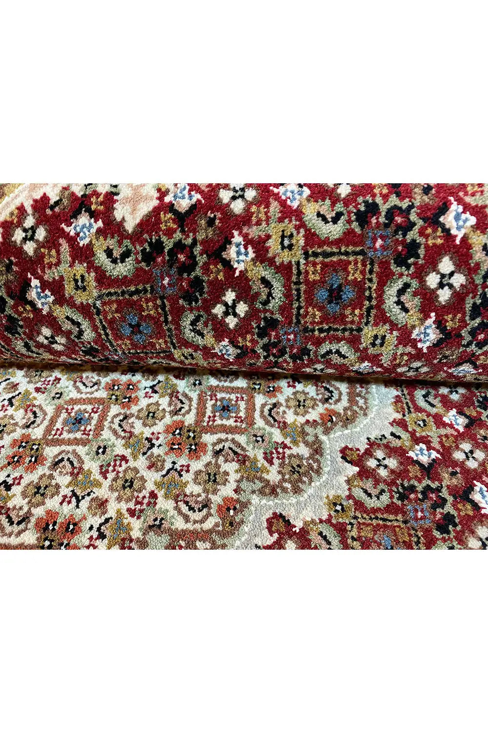 Carpet surface with a colorful mix of ornaments in red, beige, and blue