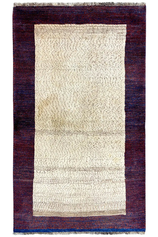 Rectangular Gabbeh rug, beige field with a dark red border and blue decorative edges