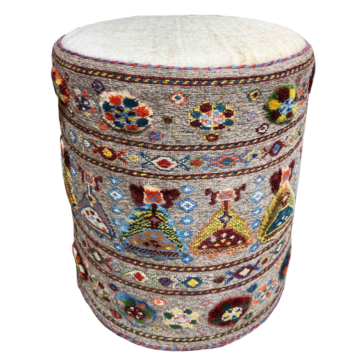 Round padded stool with light upholstery and a colorful ornamental pattern