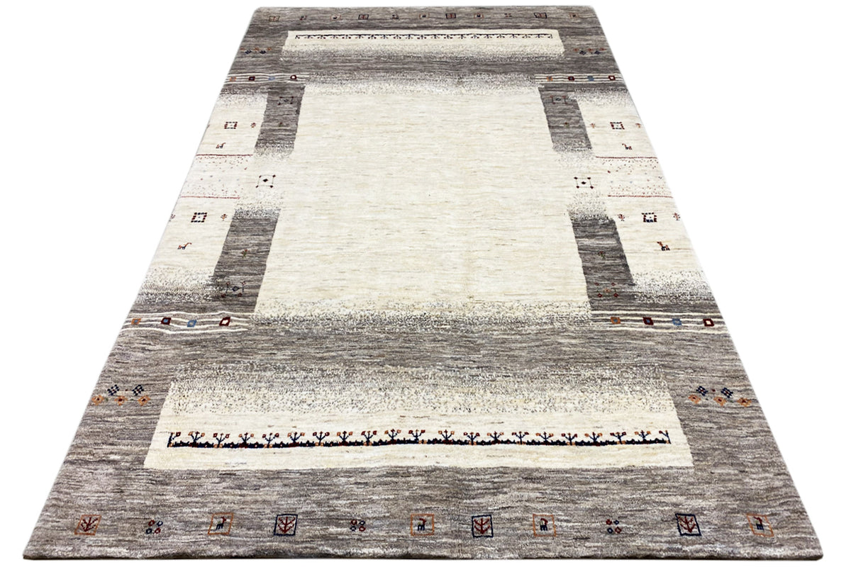 Gabbeh rug in A-shape perspective, gray-white with central medallion and border