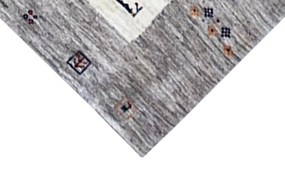 Gabbeh rug corner in detail: gray stripes, light field, small patterned ornaments