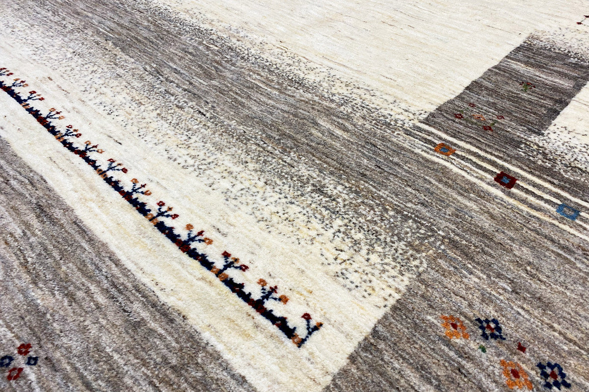 Gabbeh rug close-up of the border: dark-edged line with colorful details