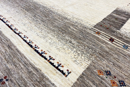 Gabbeh rug close-up of the border: dark-edged line with colorful details
