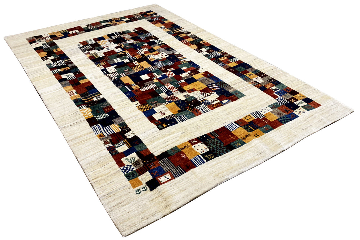 Gabbeh rug 299x200 cm, photographed at an angle: central geometric pattern on cream