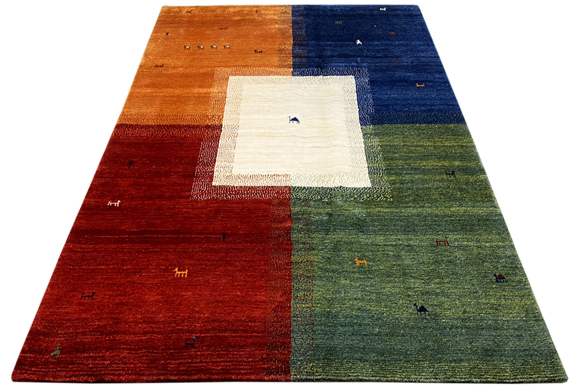 Gabbeh rug in three-quarter view: brown, blue, and green with a light corner panel