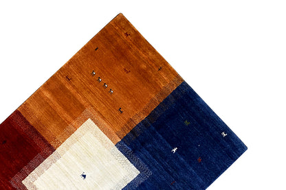 Gabbeh rug viewed from above with a brown border, blue stripe, and cream field