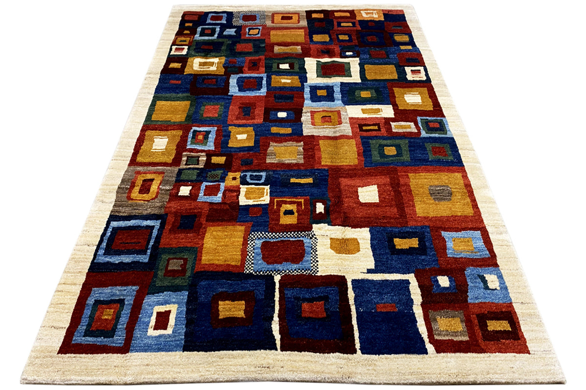 Rectangular Gabbeh rug with a colorful square design in blue, brown, and beige