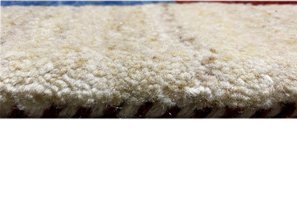 Gabbeh rug: dense, high-pile texture with a beige border and multicolored elements