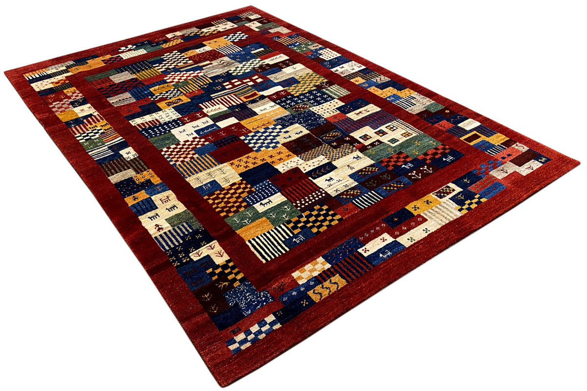 Rug with multicolored patchwork blocks and a red border, rectangular