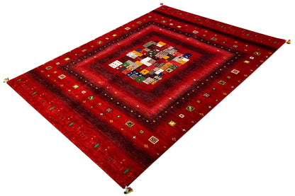 Red Gabbeh rug from above, central patchwork panel and decorative border