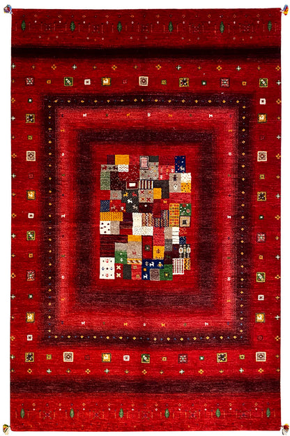 Red Gabbeh rug with a multicolored patchwork medallion and ornate border