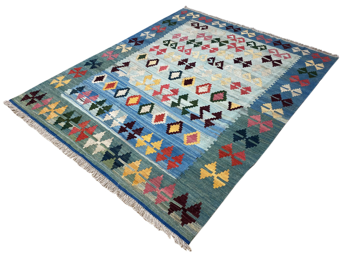 Square blue kilim rug with a colorful cross and diamond pattern, corner fringes