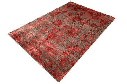 Rectangular rug with a fine textured pattern in red and gray, even pile