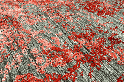 Detailed view of the carpet pattern in red and gray with subtle, relief-like color gradients