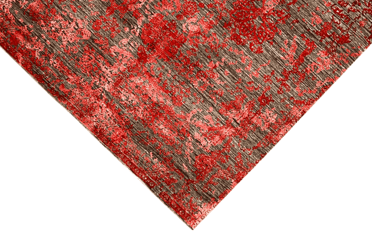 Designer rug with an abstract red and gray pattern, decorative texture in the corner