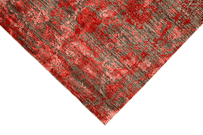 Designer rug with an abstract red and gray pattern, decorative texture in the corner