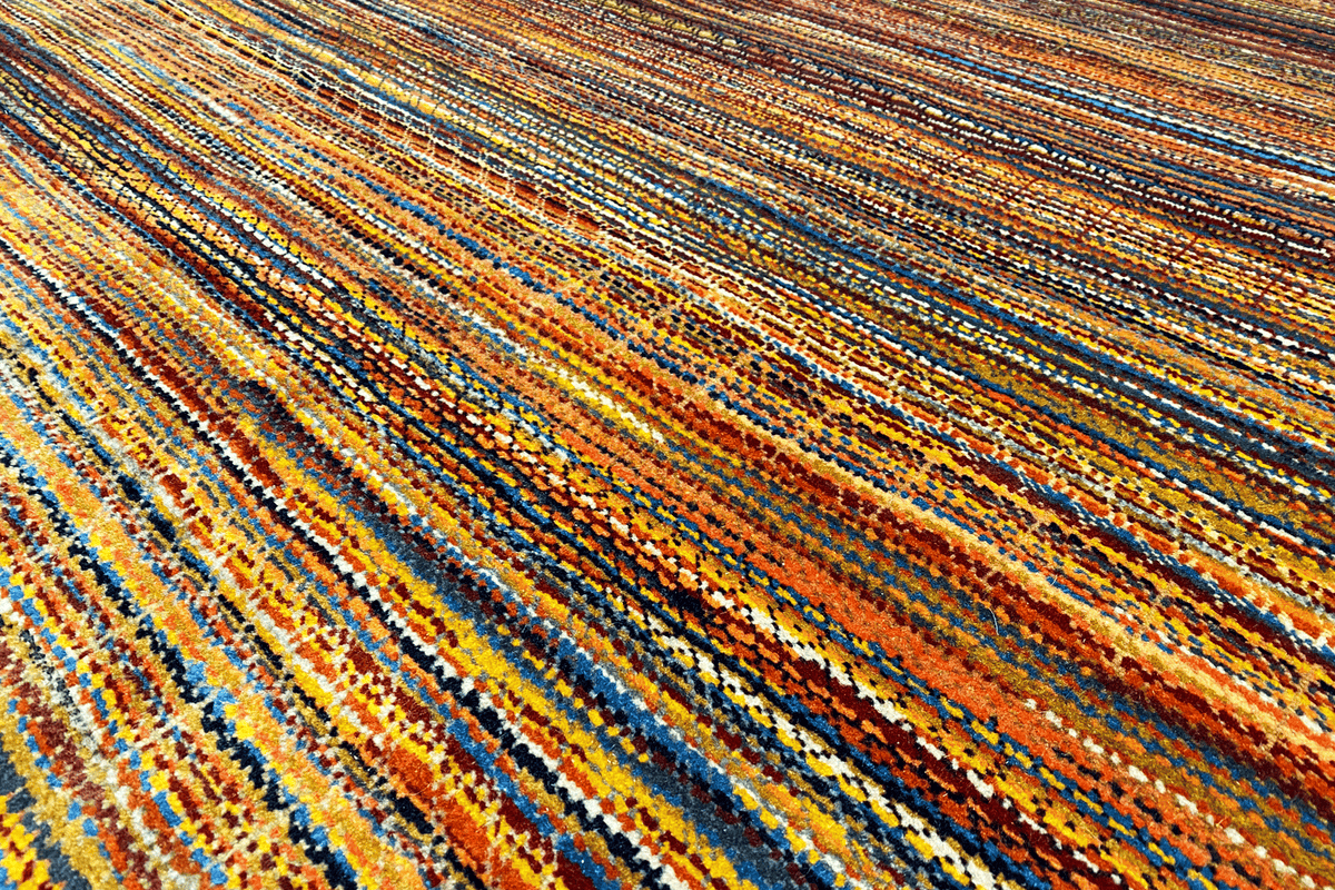 Rug surface with horizontal stripes in blue, orange, and yellow