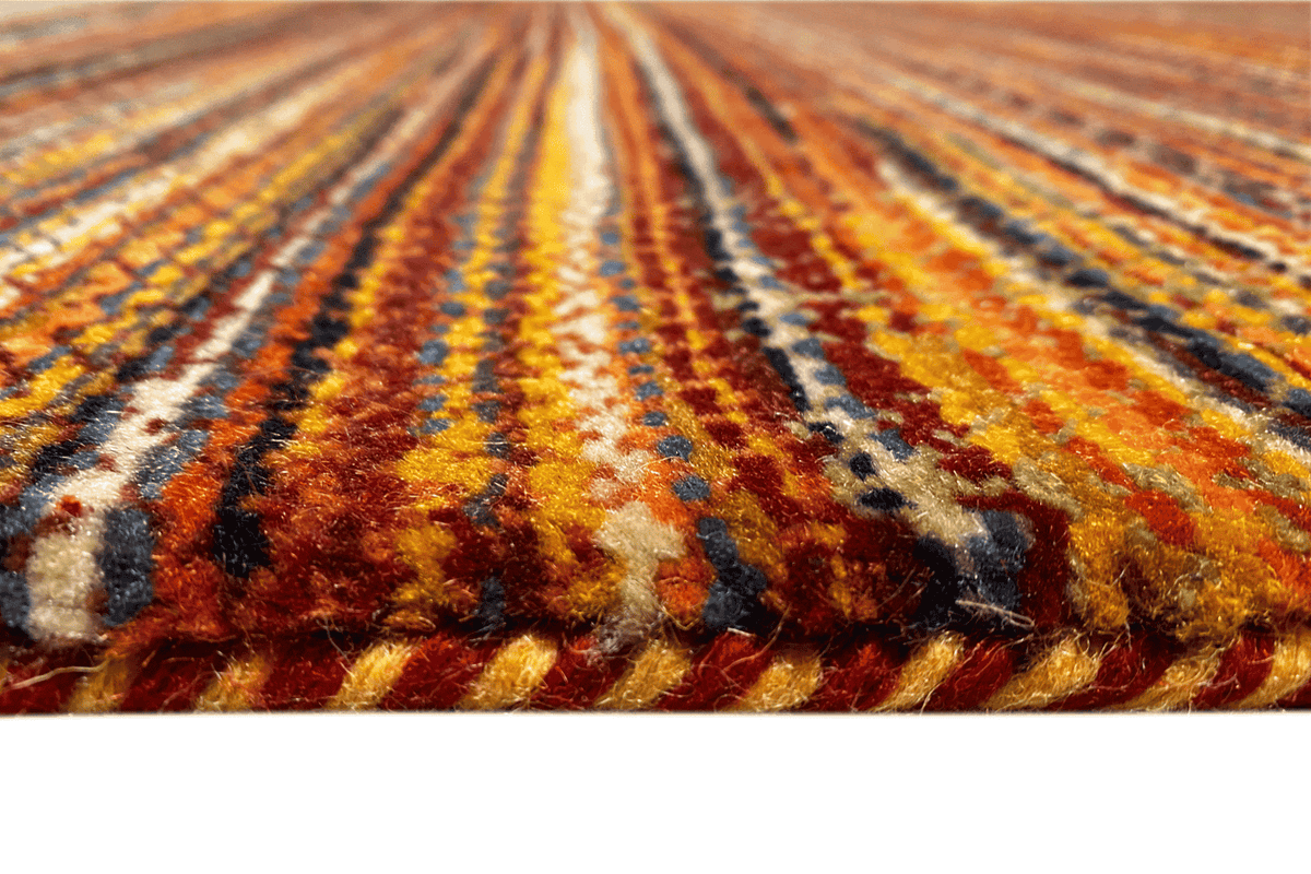 Close-up of the wool rug: multicolored stripes, visible pile texture
