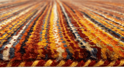 Close-up of the wool rug: multicolored stripes, visible pile texture
