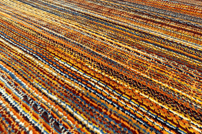 Close-up: multicolored lines in the wool rug with fine contrasting stripes