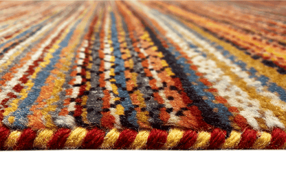 Hand-knotted rug detail: multicolored wool, fringed border