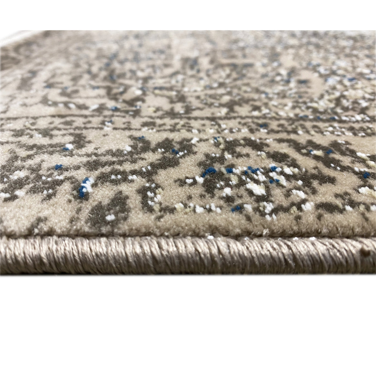Beige carpet pile with a dark pattern and blue accents along the edge