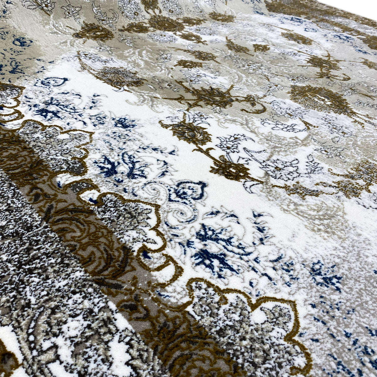 Detailed view: beige ornamental pattern in golden brown and blue on the carpet surface