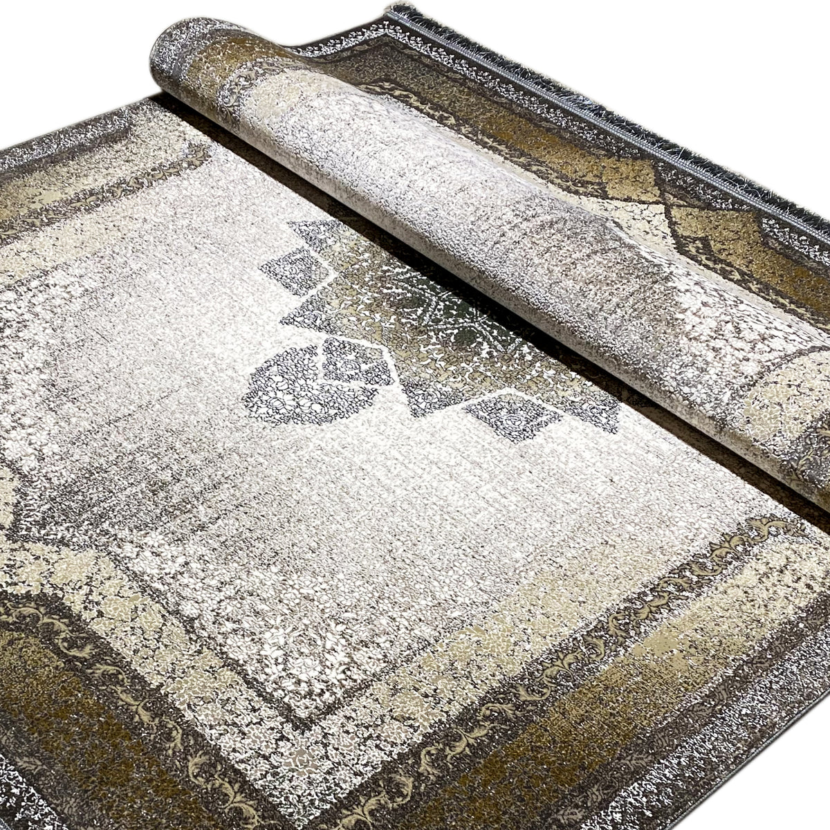 Rolled-up carpet: close-up of the pattern with a medallion, geometric elements, and a surrounding border