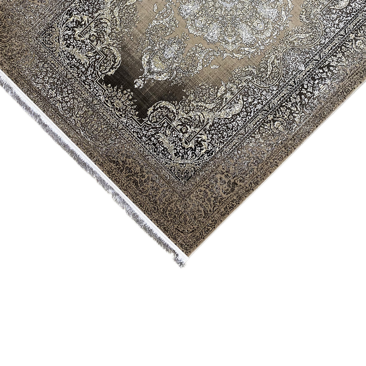 Rug corner detail: silver medallion, dark pattern, bordered edge