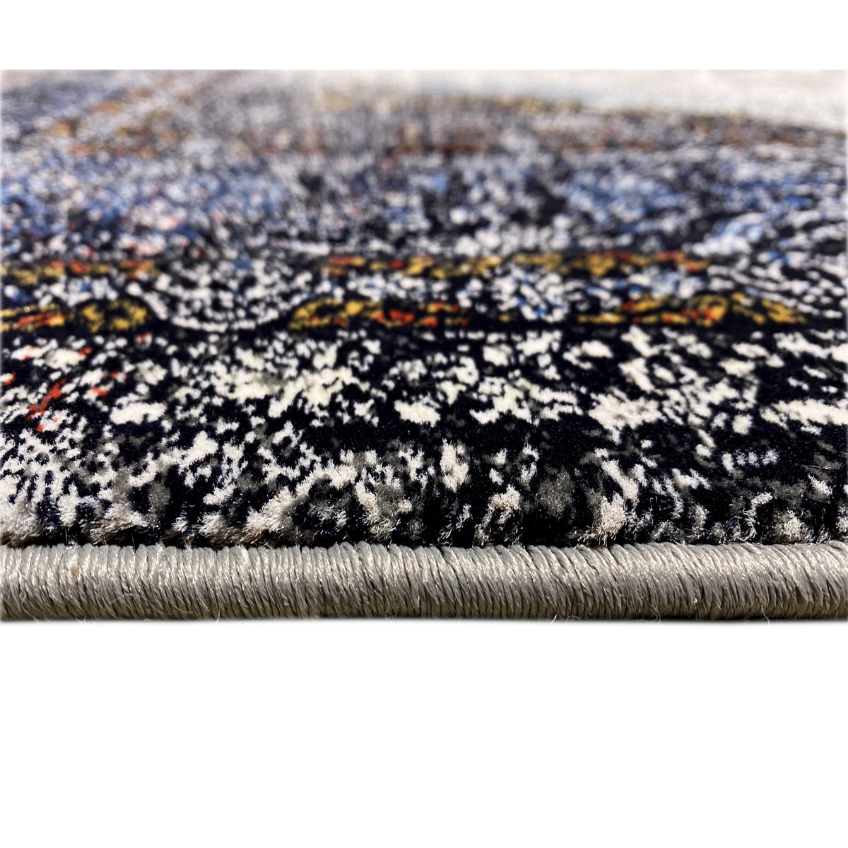 Rug with a multicolored, heathered pattern and fringes along the edge, in shades of black and blue