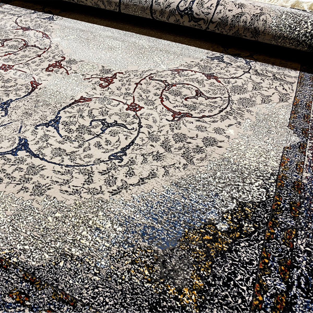 Carpet detail with Baroque ornaments in gray, blue, and red, as well as textured, mottled pile