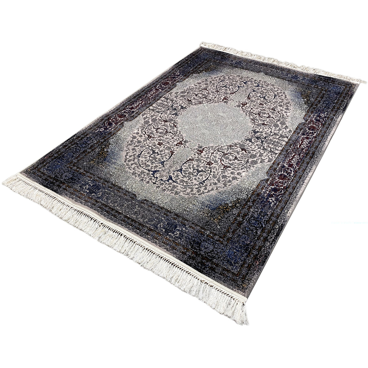Rug at an angle with a light gray medallion, dark border, and long fringes