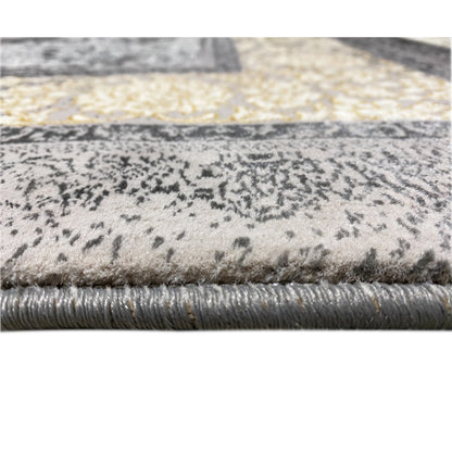 Rug detail: pile with dark patterns on a beige background, visible short fringes