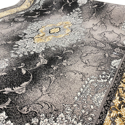 Carpet detail: delicate floral pattern with a gold-colored center, contrasting against a silver-gray background
