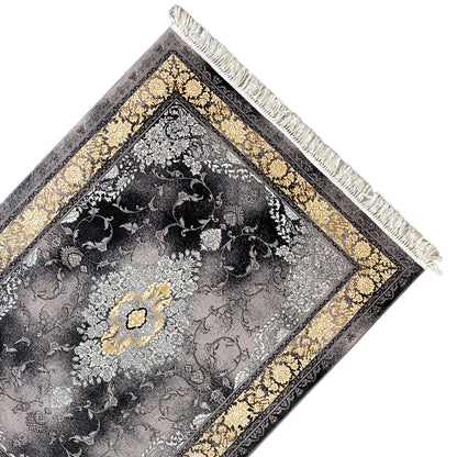 Carpet corner with a gray ornamental pattern, gold border, and white fringe