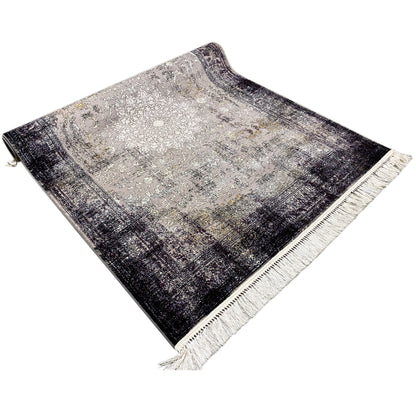 Woven vintage rug with an all-over pattern, dark border, light pattern elements, and fringes
