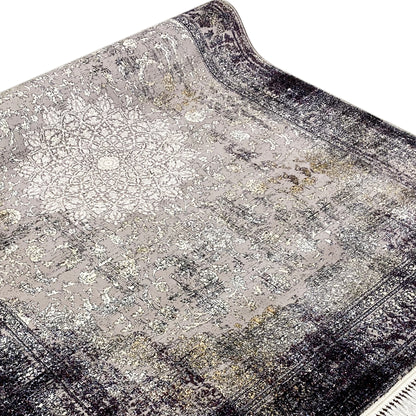 Close-up: vintage rug with an ornament/tile pattern, gray-beige surface, dark border, and fringe