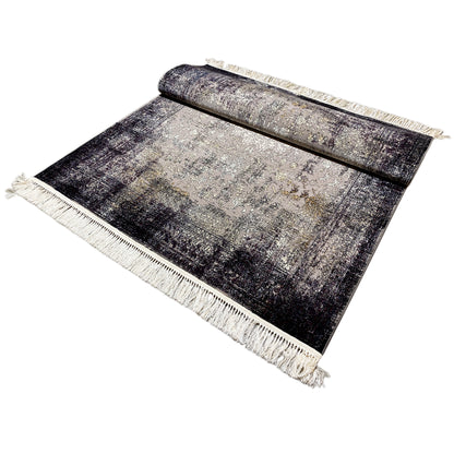 Rectangular vintage rug, textured pattern, dark and light areas, fringes all around