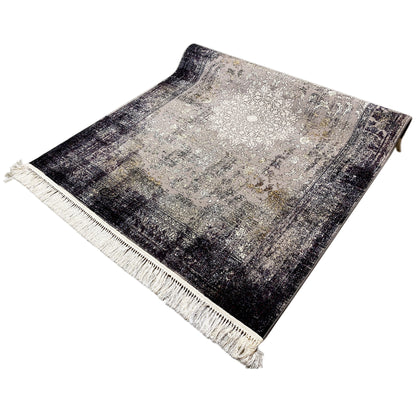 Vintage rug with a gray-beige center and dark textured stripes, fringes along the edges