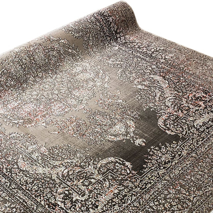 Oriental rug with a large central medallion and contrasting decorative borders, rolled