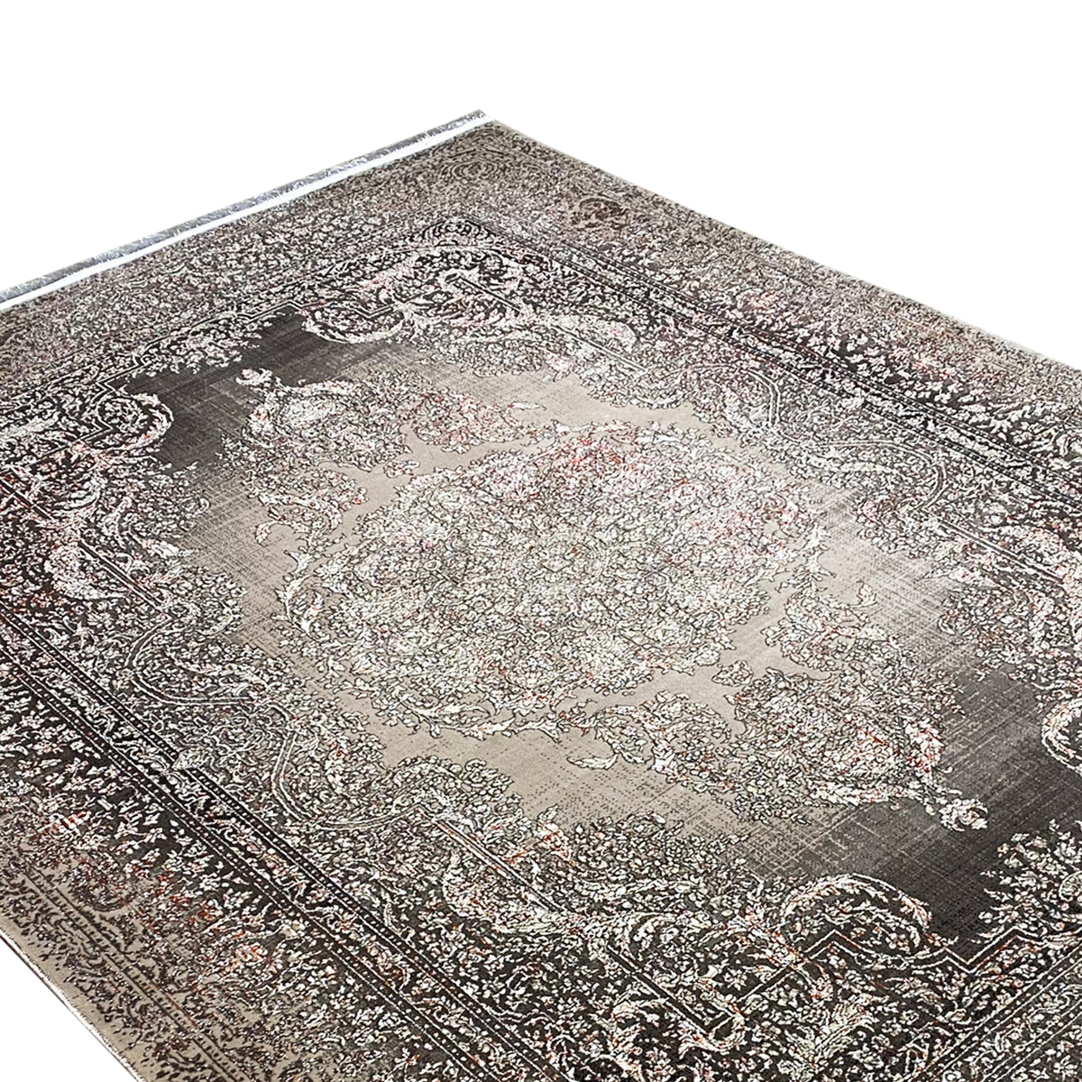 Rug surface with a silver-gray center and dark paisley ornaments, fine texture