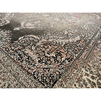 Close-up of the carpet pattern: silver-gray and dark ornaments with small touches of color