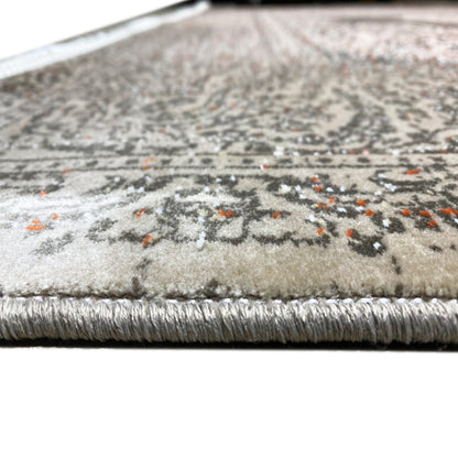 Rug edge with fringes and a silver-gray patterned surface, tightly woven texture
