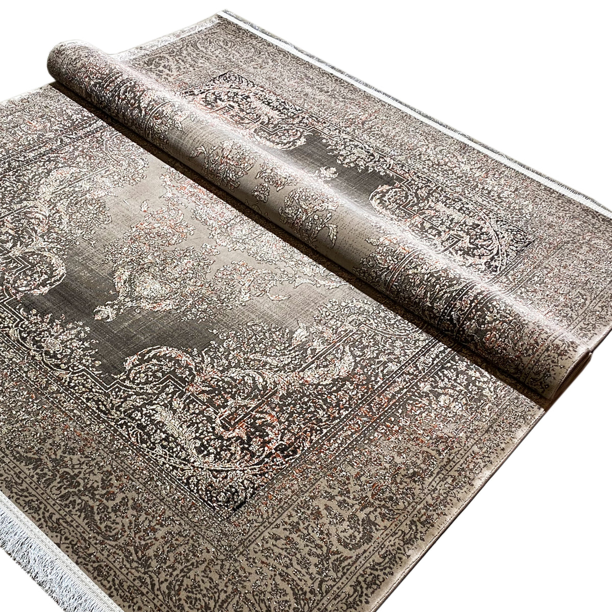 Rolled rug: silver-gray vintage ornament with a dark border and fringes