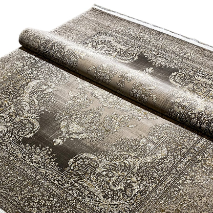 Rug with a silver-beige and dark gray paisley pattern, rolled up