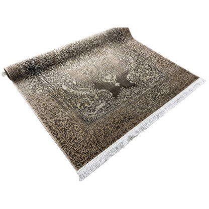 Rectangular dark gray rug with a baroque ornamental pattern and white fringes